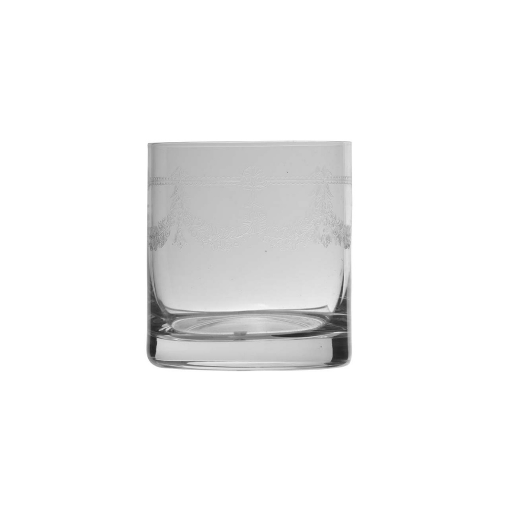 A clear glass rocks tumbler with a thick base and subtle etched floral detailing near the rim, shown against a plain white background.