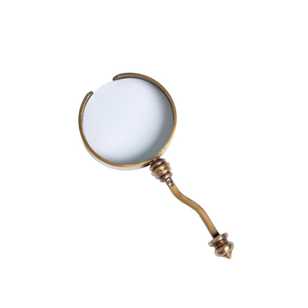 A vintage-style brass magnifying glass with a curved handle and a clear glass lens, shown on a solid white background.