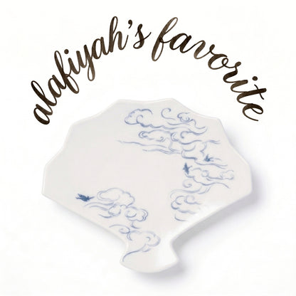 A white ceramic dish with a blue cloud pattern, displayed on a white background with the text 'alafiyah's favorite' written in brown script above it.