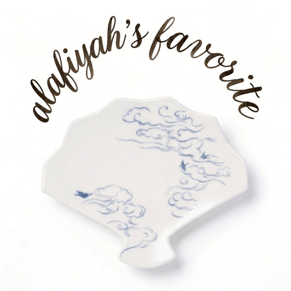 A white ceramic dish with a blue cloud pattern, displayed on a white background with the text 'alafiyah's favorite' written in brown script above it.