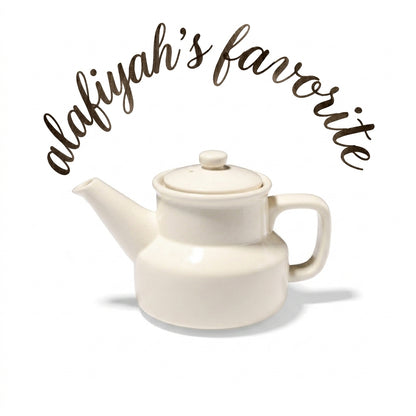 An off-white ceramic teapot with a lid, spout, and handle, shown on a white background with the text 'alafiyah's favorite' written in brown script above it.