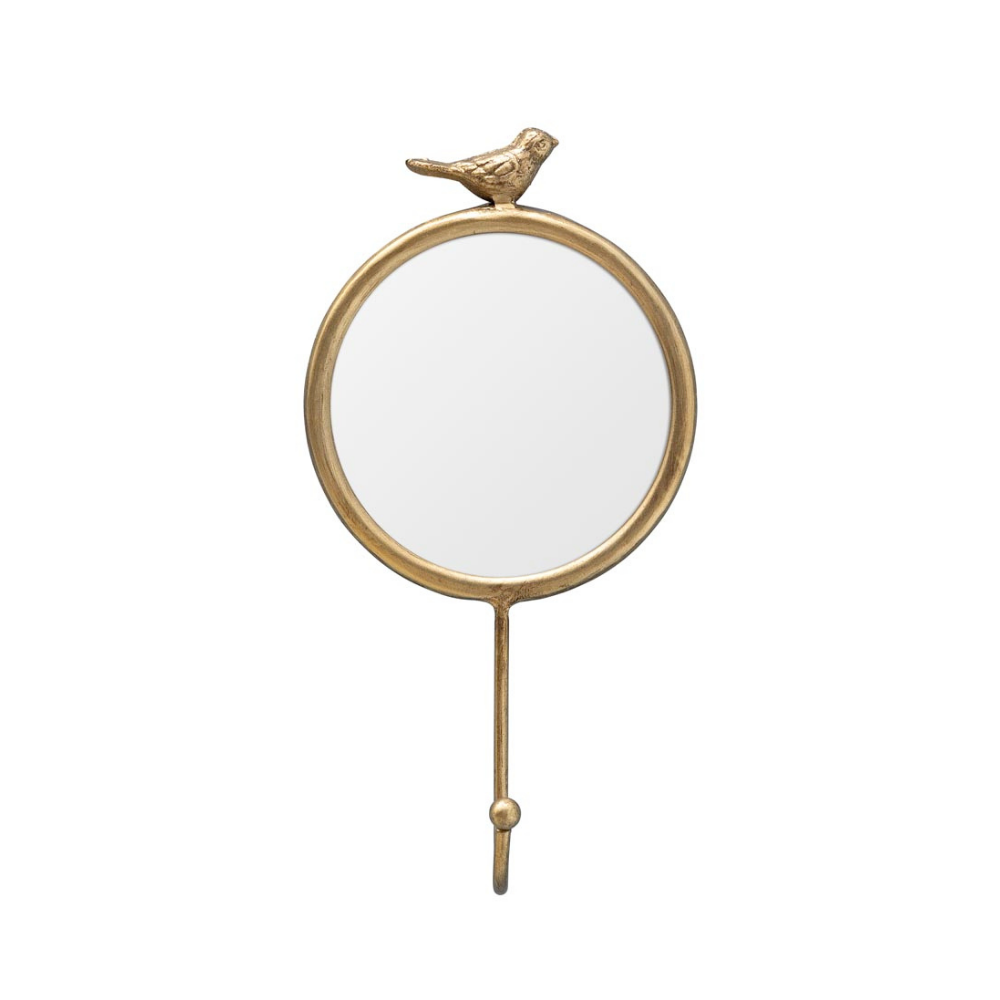 A round wall mirror with a gold-toned metal frame, featuring a small bird perched on the top edge and a hanging hook at the bottom, shown against a plain white background.
