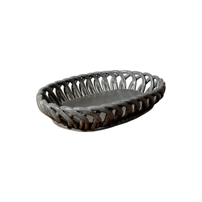 A dark gray ceramic oval basket tray with a solid gray interior, shown on a plain white background.