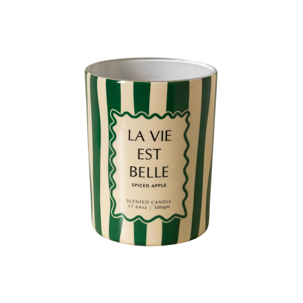 A ceramic scented candle with a green and cream striped pattern, featuring a central cream label with the French text 'LA VIE EST BELLE' and 'SPICED APPLE'.