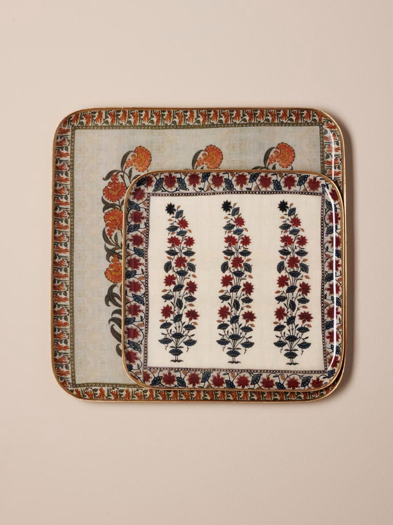 Decorative tray with floral patterns on a beige background.