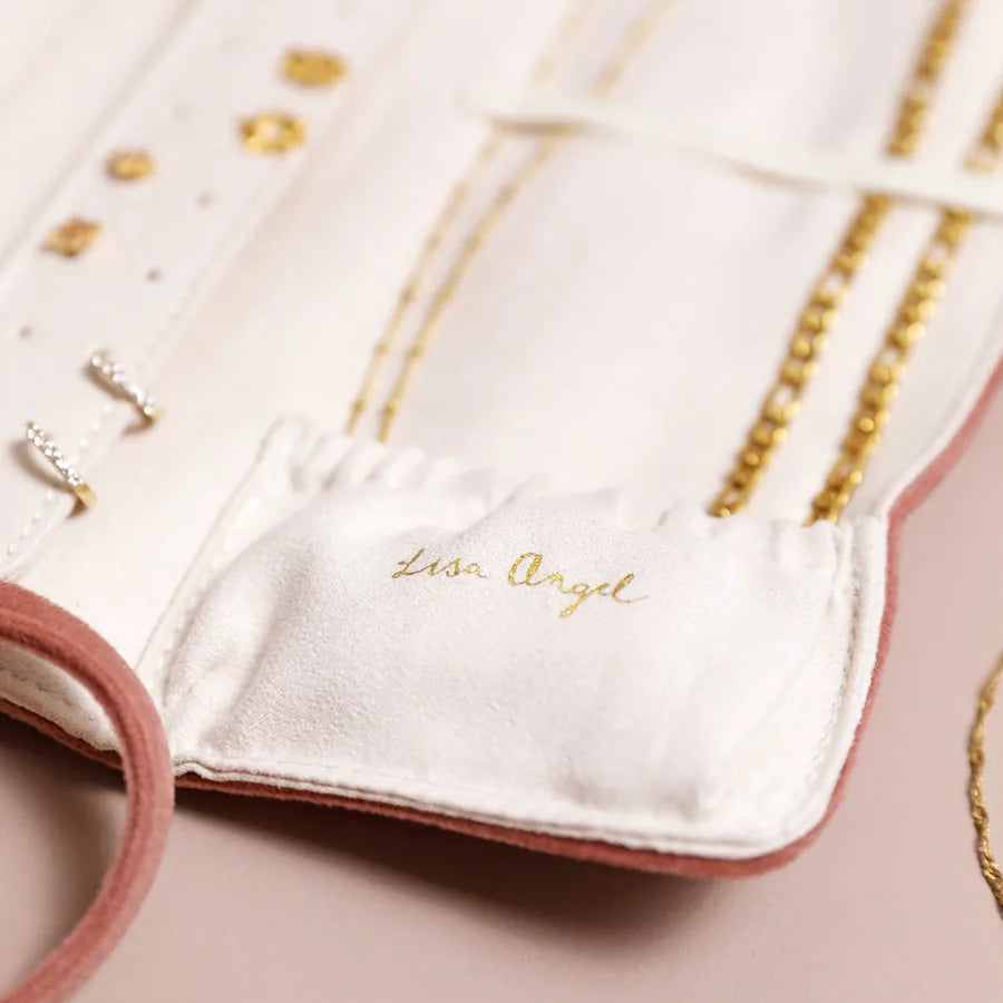 White glove with gold accents and 'Lion Angel' branding on a pink background