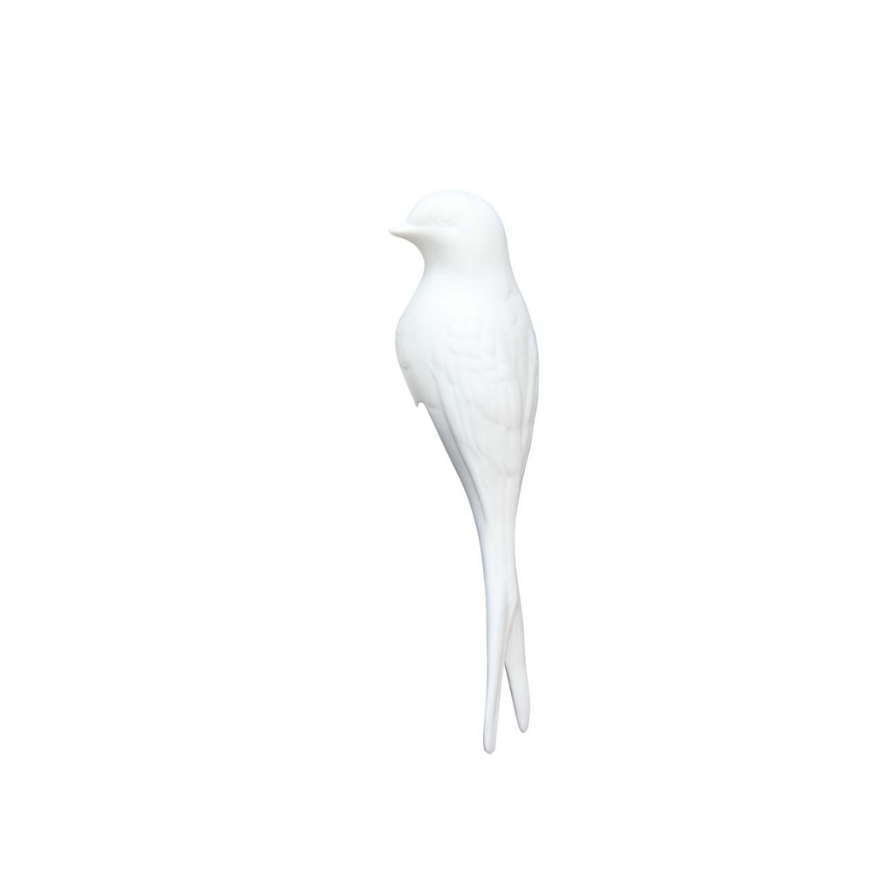 A white bird figurine, shaped like a swallow with a long tail, shown in profile against a solid white background.