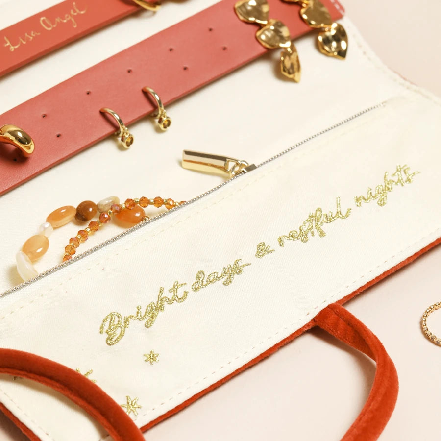 Jewelry set with red and gold accents on a white surface