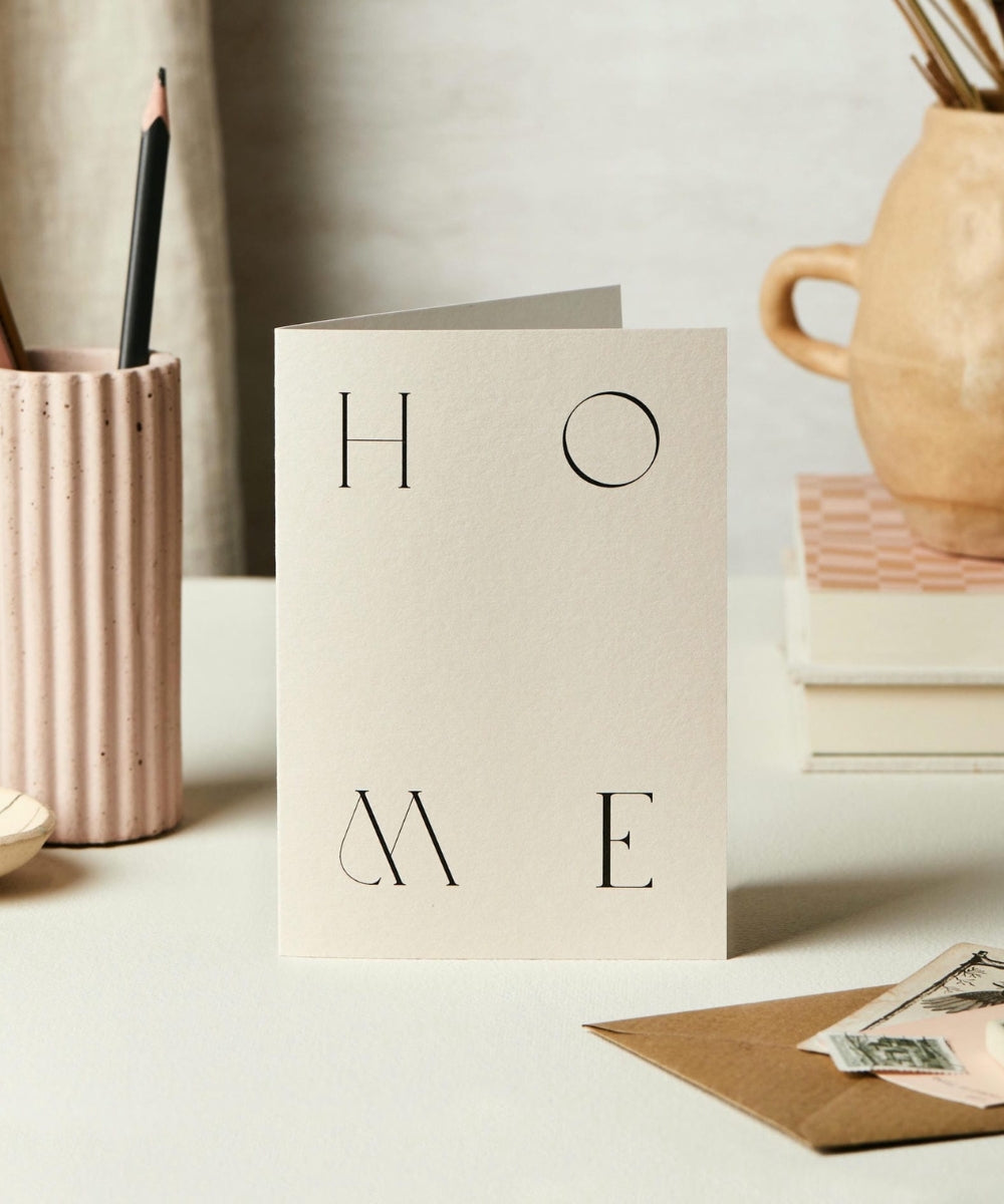 H-O-M-E - minimalist cream-colored card word home