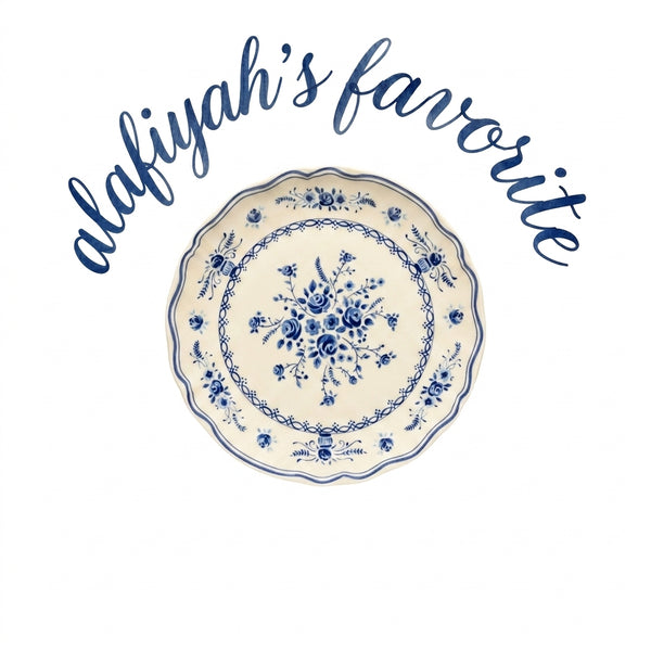 A round ceramic plate with a blue floral and scroll pattern on an off-white background, under the text 'alafiyah's favorite' in blue cursive script on a white background.