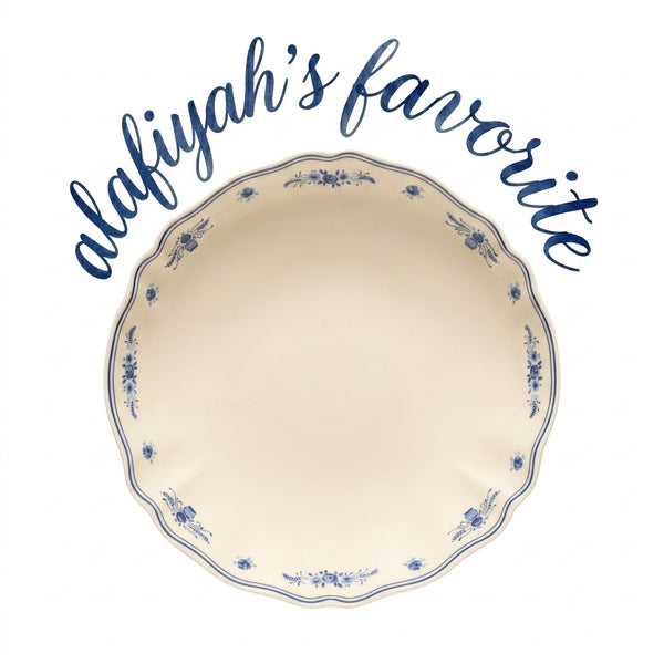 An off-white scalloped ceramic plate with blue floral patterns around the rim, under the text 'alafiyah's favorite' in blue script on a white background.